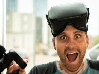 Man wearing VR headset excited