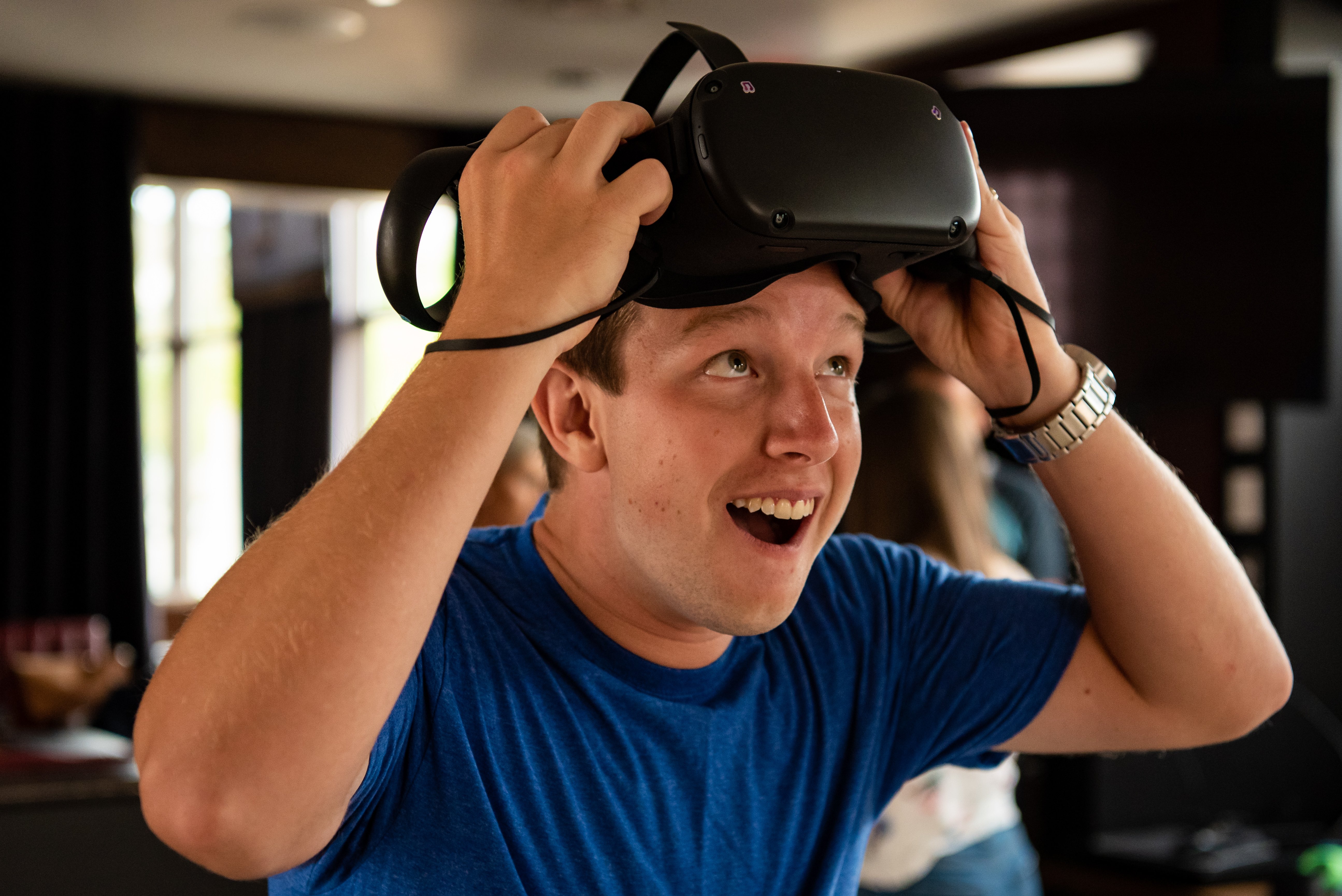 Man taking off VR headset