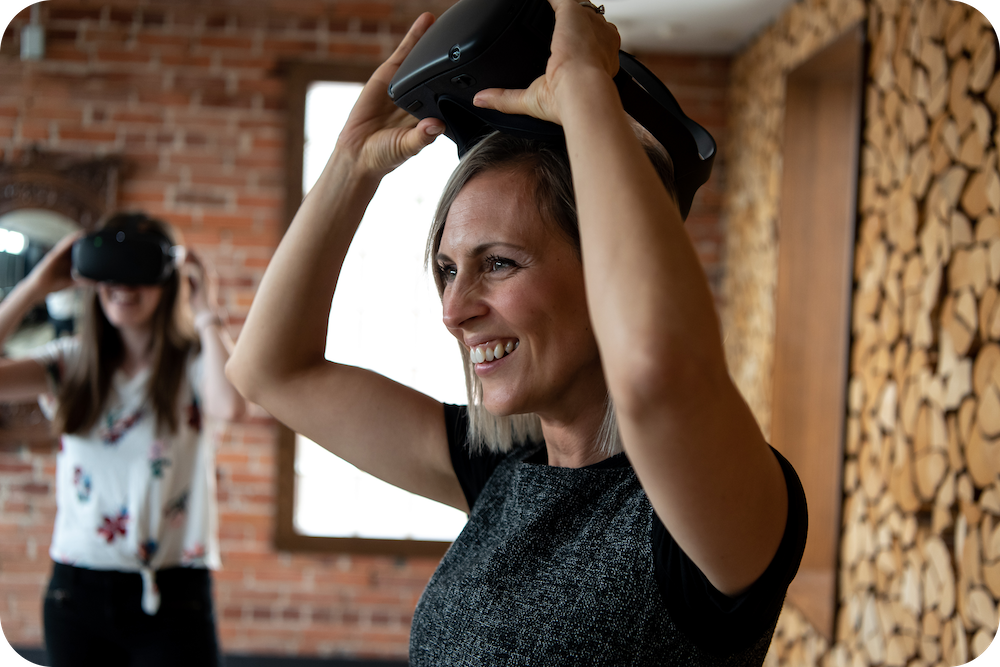 Woman taking off VR headset